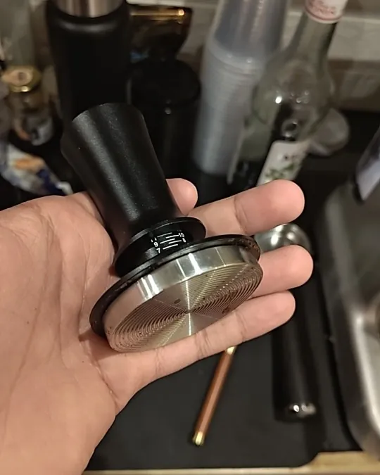 Calibrated coffee tamper photographed at home by a verified buyer — Straight 58mm