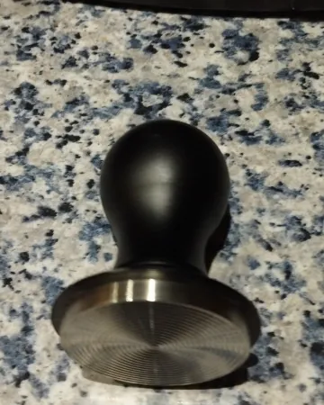 Calibrated coffee tamper photographed at home by a verified buyer — Rounded 53mm 54mm